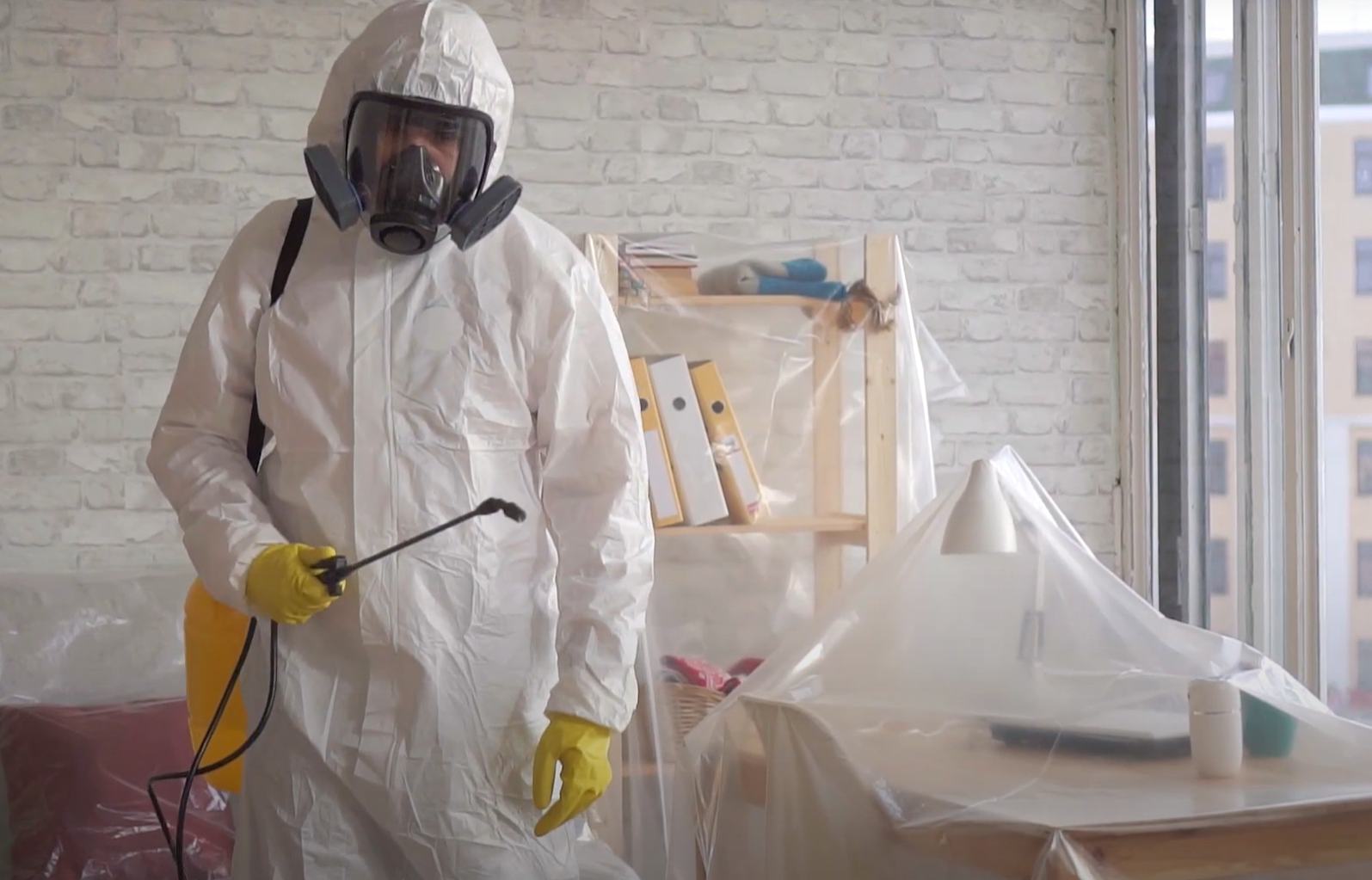 Technician in full protective suit and respirator preparing pest treatment — Pest Control Service in Napa.